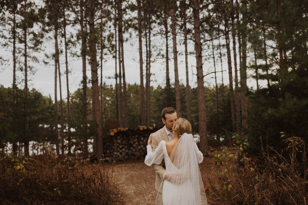 Bride and groom kiss at winter wedding venue in Minnesota