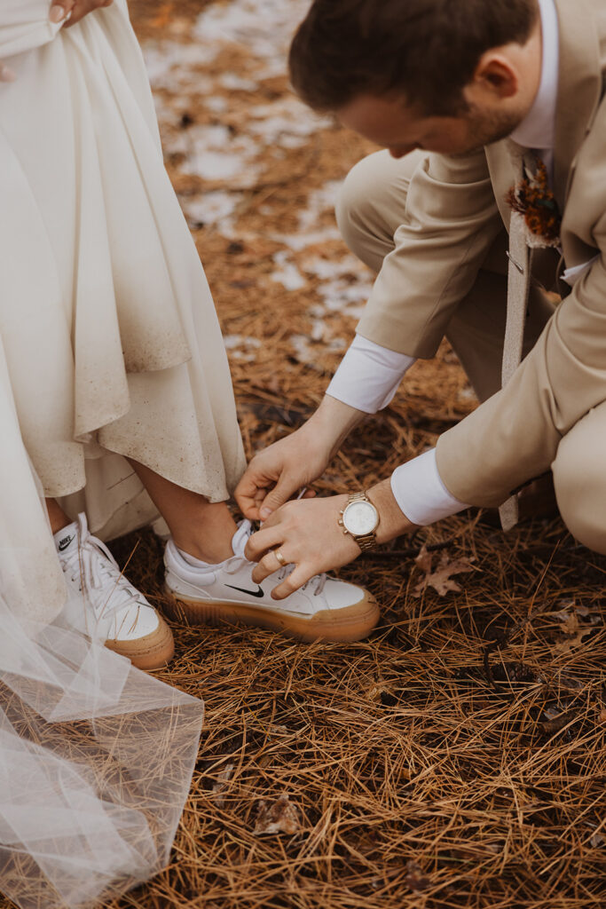 Groom fixes bride's Nike's shoes