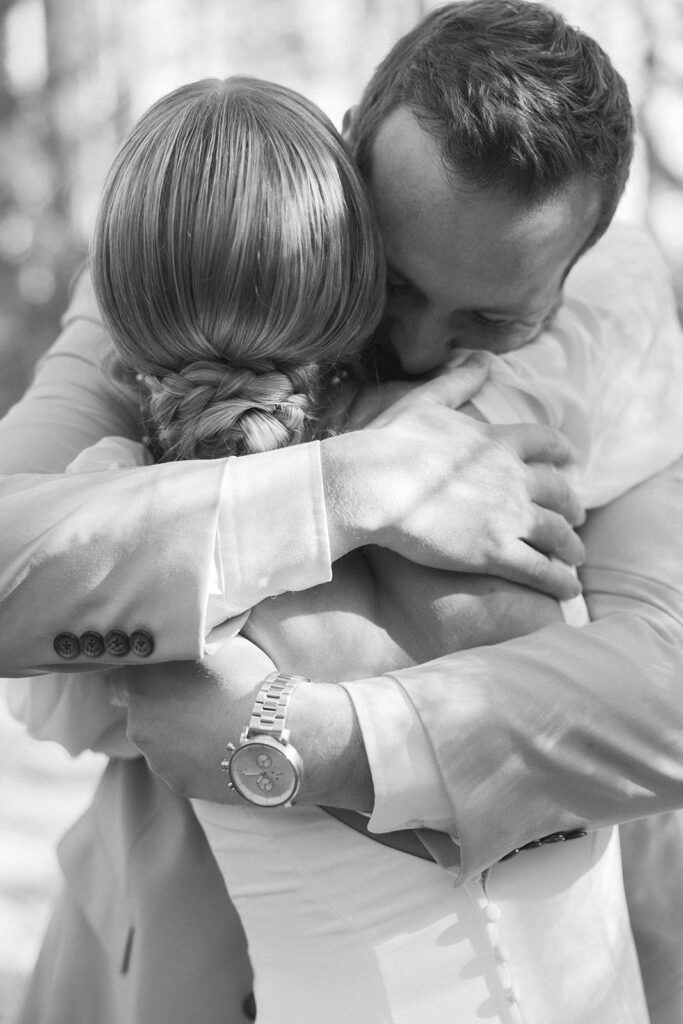 Groom hugs bride during emotional first look at winter wedding venue in Minnesota