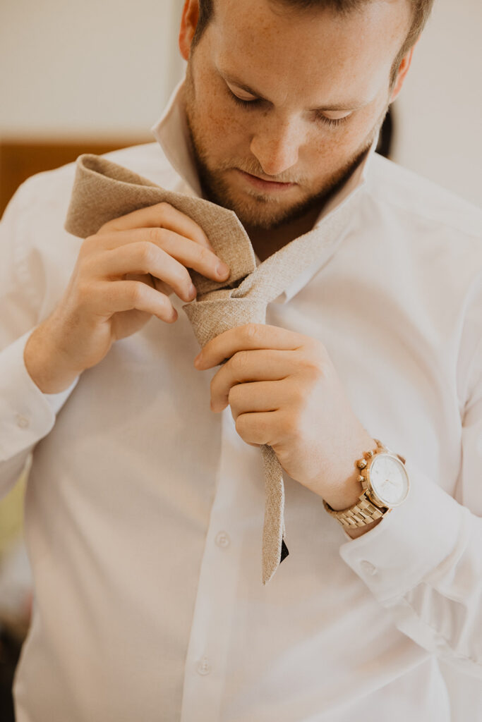 Groom fixes his tie