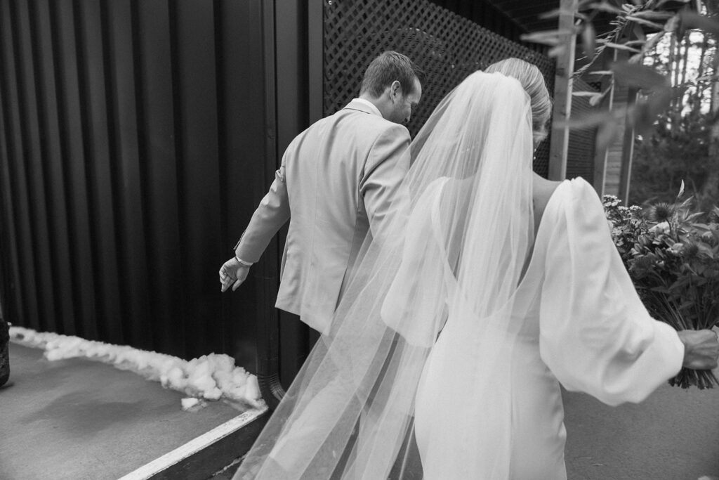 Bride and groom walk into winter wedding venue in Minnesota