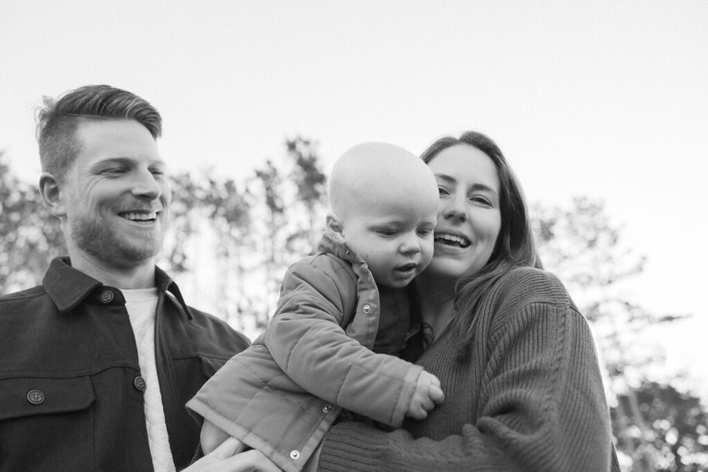 Young family poses in Minnesota field