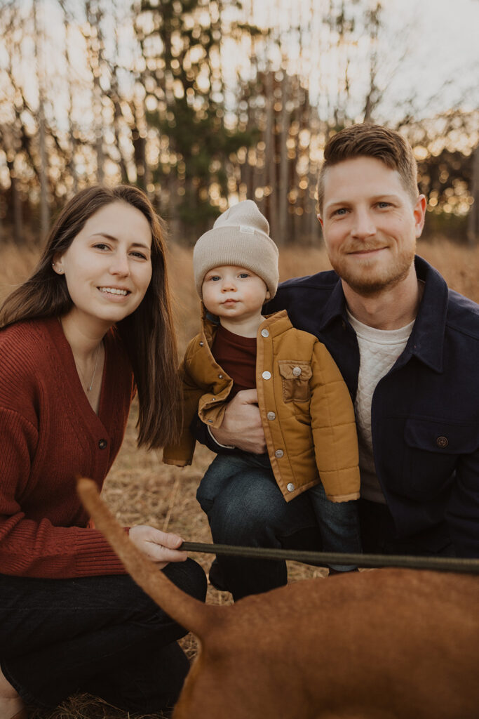 Young family with dog poses in Minnesota autumn light