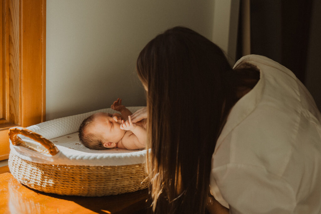 Mom speaks quietly to newborn baby on changing table