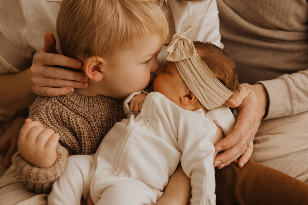 New big brother kisses his baby sister's nose