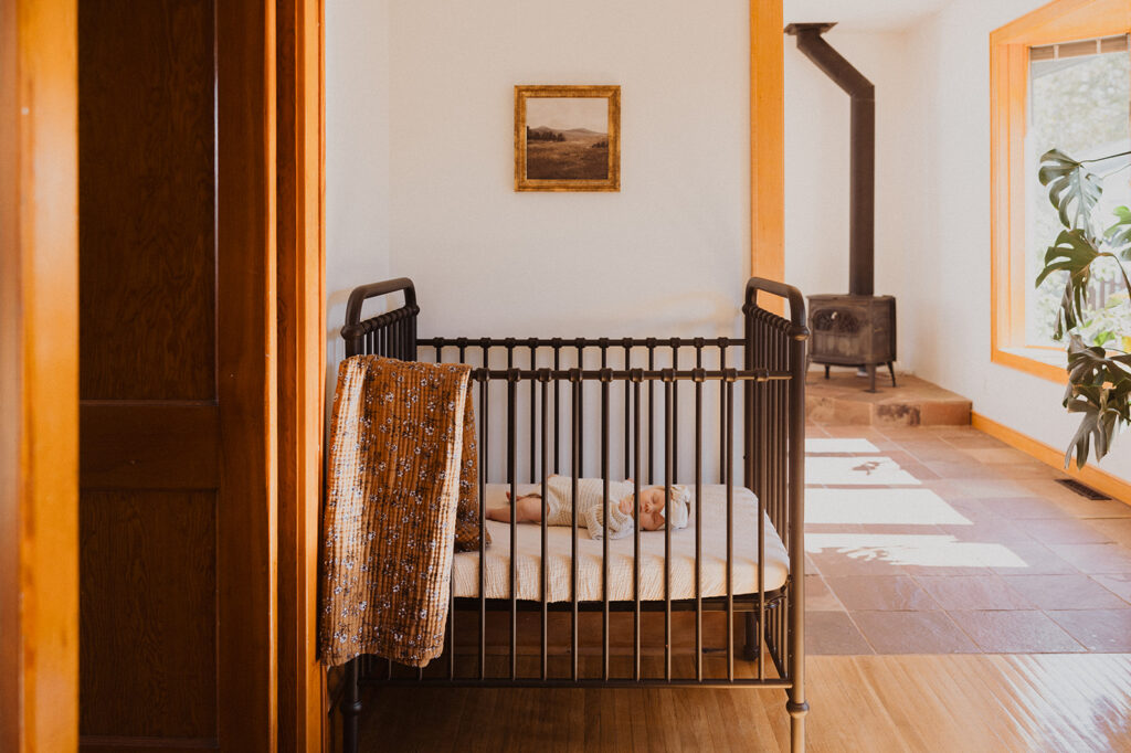 Newborn baby sleeps sounds in Nordic crib in sunlit living room